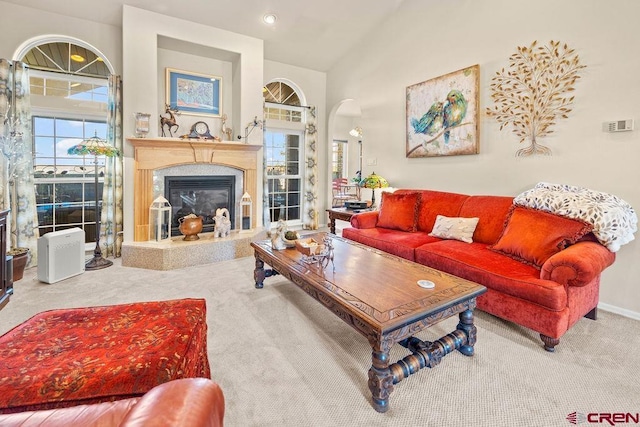 1060 Alta Vista Dr, Craig, CO 81625 - living room featuring carpet flooring, arched walkways, a premium fireplace, lofted ceiling, and baseboards