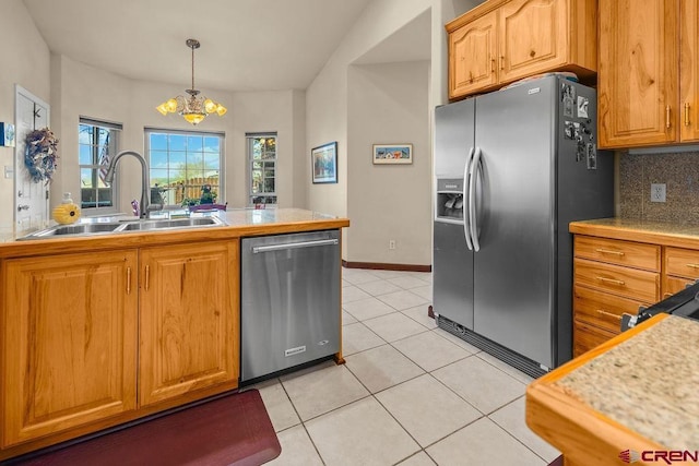 1060 Alta Vista Dr, Craig, CO 81625 - kitchen with stainless steel appliances, a sink, a chandelier, light tile patterned flooring, and decorative backsplash