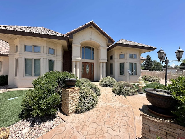20 Meadow Ln, Monte Vista, CO 81144 - view of front of house featuring a tile roof, stucco siding, and fence