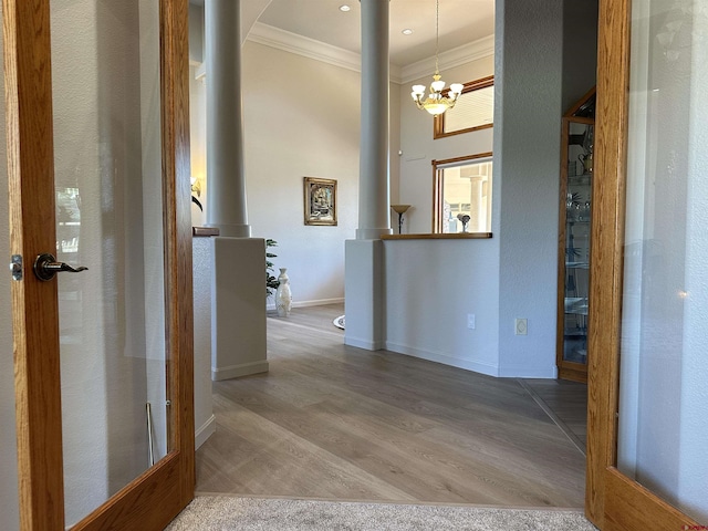20 Meadow Ln, Monte Vista, CO 81144 - hallway featuring crown molding, a chandelier, wood finished floors, decorative columns, and baseboards