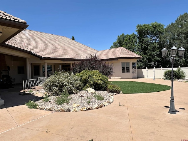 20 Meadow Ln, Monte Vista, CO 81144 - rear view of house with a tiled roof, fence, a patio area, and stucco siding