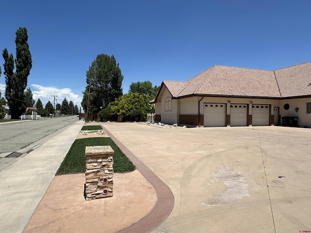20 Meadow Ln, Monte Vista, CO 81144 - view of property exterior with a garage, driveway, and a tiled roof