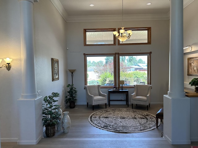 20 Meadow Ln, Monte Vista, CO 81144 - sitting room featuring decorative columns, a chandelier, wood finished floors, a high ceiling, and baseboards