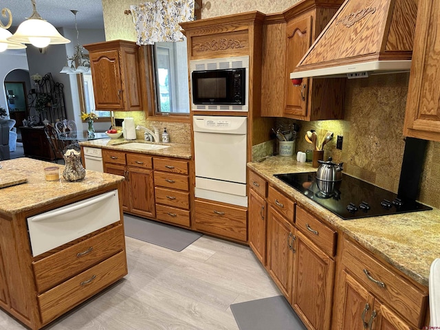 20 Meadow Ln, Monte Vista, CO 81144 - kitchen featuring a warming drawer, premium range hood, black appliances, a sink, and decorative backsplash