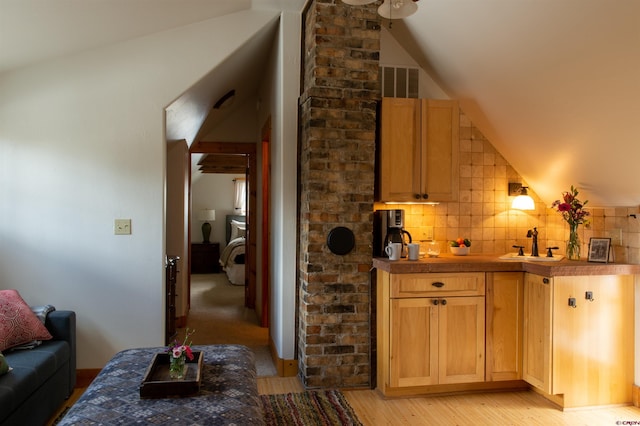 209 Whiterock Ave, Crested Butte, CO 81224 - bar with a sink, vaulted ceiling, light wood-style flooring, and decorative backsplash