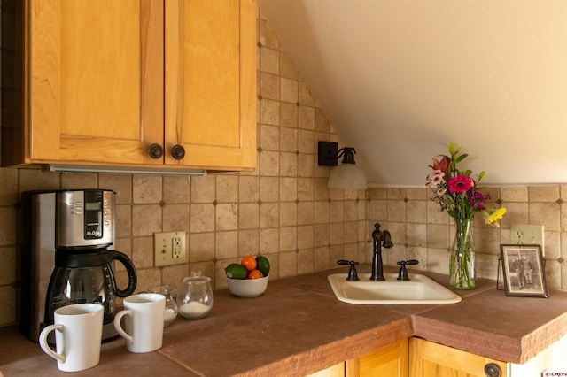 209 Whiterock Ave, Crested Butte, CO 81224 - kitchen featuring a sink, backsplash, lofted ceiling, and dark countertops