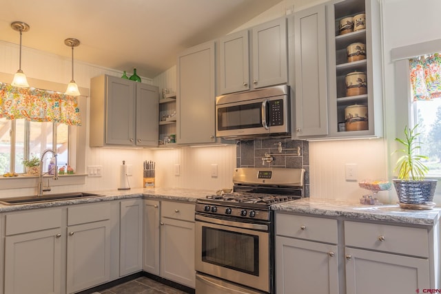 kitchen with stainless steel appliances, a sink, backsplash, decorative light fixtures, and open shelves