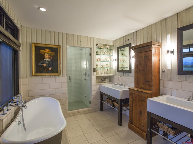1789 County Road 44z S, Norwood, CO 81423 - full bathroom with tile walls, tile patterned floors, a shower stall, a freestanding bath, and a sink