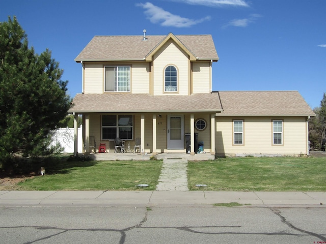 view of front of property with a porch, a front yard, and roof with shingles