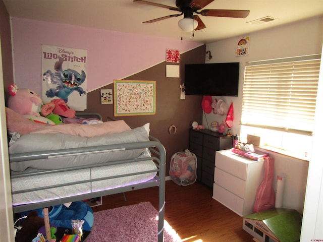 bedroom with wood finished floors and a ceiling fan