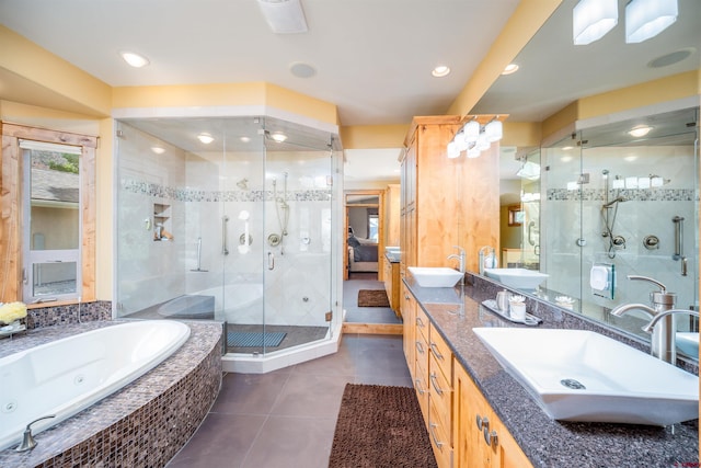 9 Pebble Dr, Durango, CO 81301 - ensuite bathroom featuring tile patterned flooring, a tub with jets, a shower stall, and double vanity