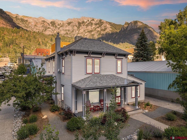 645 2nd St, Ouray, CO 81427 - view of front facade featuring a chimney, a mountain view, and a shingled roof