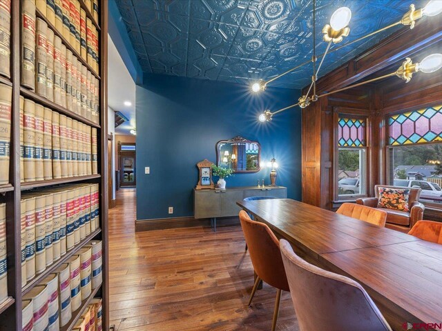 645 2nd St, Ouray, CO 81427 - dining area with hardwood / wood-style flooring, an ornate ceiling, and baseboards