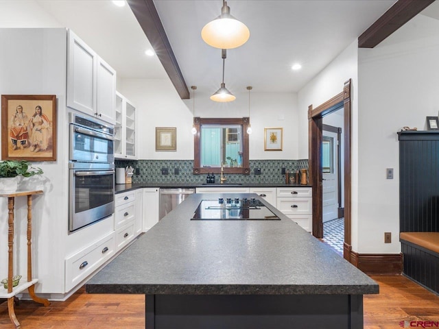 645 2nd St, Ouray, CO 81427 - kitchen with dark countertops, appliances with stainless steel finishes, white cabinetry, tasteful backsplash, and recessed lighting