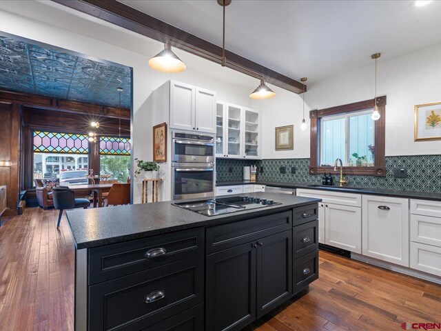 645 2nd St, Ouray, CO 81427 - kitchen with stainless steel appliances, a sink, dark countertops, white cabinets, and dark cabinetry