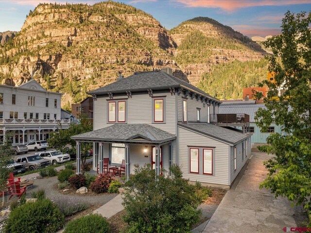 645 2nd St, Ouray, CO 81427 - view of front of home with covered porch, a mountain view, and a shingled roof