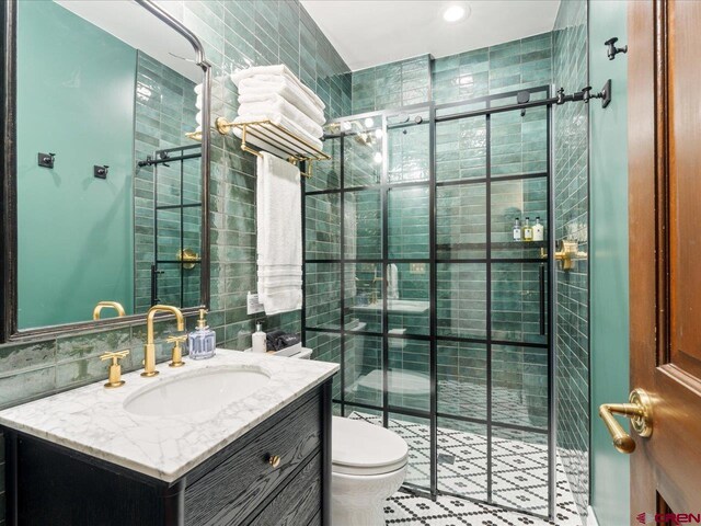 645 2nd St, Ouray, CO 81427 - full bathroom with tile walls, a shower stall, toilet, and vanity