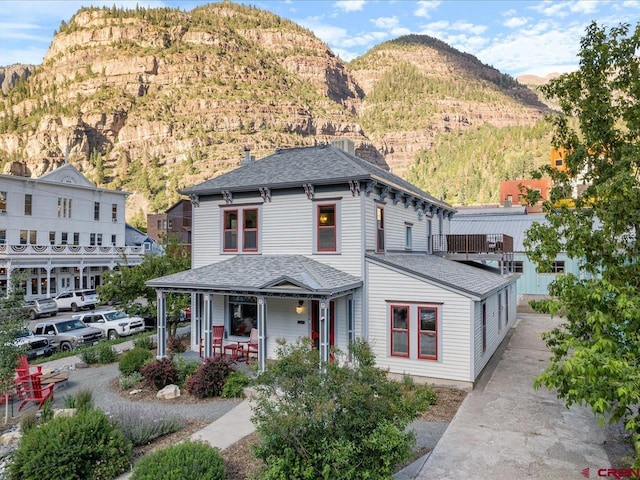 645 2nd St, Ouray, CO 81427 - view of front facade featuring a porch, a mountain view, and a shingled roof