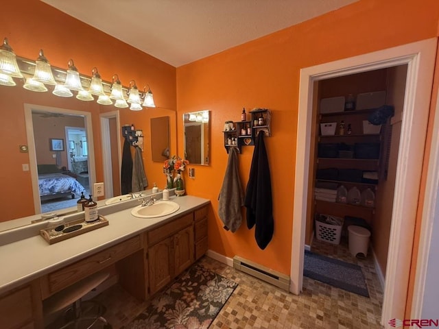 15556 D Rd, Delta, CO 81416 - ensuite bathroom featuring a baseboard radiator, vanity, and baseboards