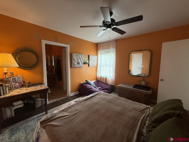 15556 D Rd, Delta, CO 81416 - bedroom with baseboards, connected bathroom, and ceiling fan