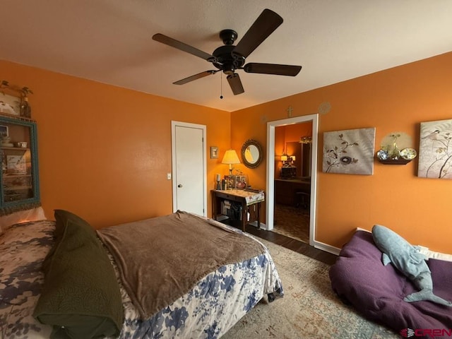 15556 D Rd, Delta, CO 81416 - bedroom featuring wood finished floors, a ceiling fan, and baseboards