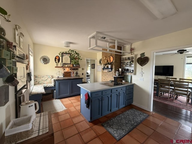 15556 D Rd, Delta, CO 81416 - kitchen featuring blue cabinetry, ceiling fan, light tile patterned flooring, a peninsula, and black electric stovetop