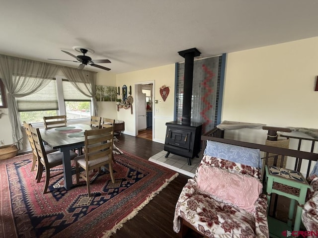 15556 D Rd, Delta, CO 81416 - dining area with a wood stove, ceiling fan, and wood finished floors