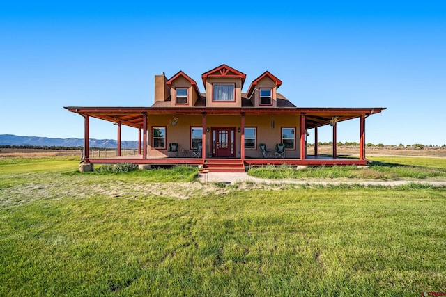 11611 Rd 28.1, Dolores, CO 81323 - farmhouse inspired home featuring a front yard, a chimney, a mountain view, and covered porch