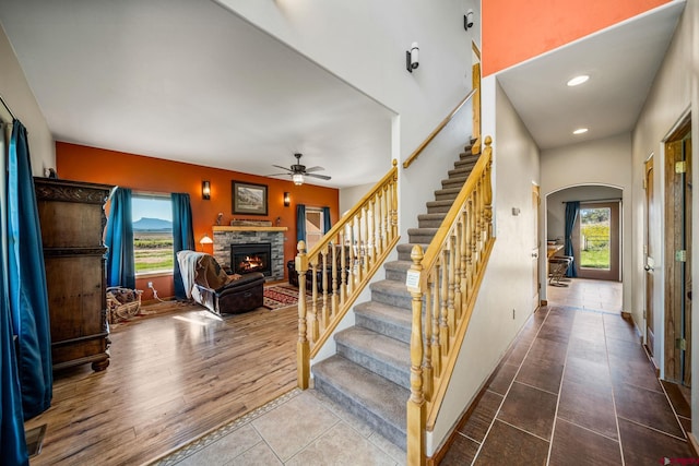 11611 Rd 28.1, Dolores, CO 81323 - stairs with a fireplace, a ceiling fan, arched walkways, tile patterned floors, and recessed lighting