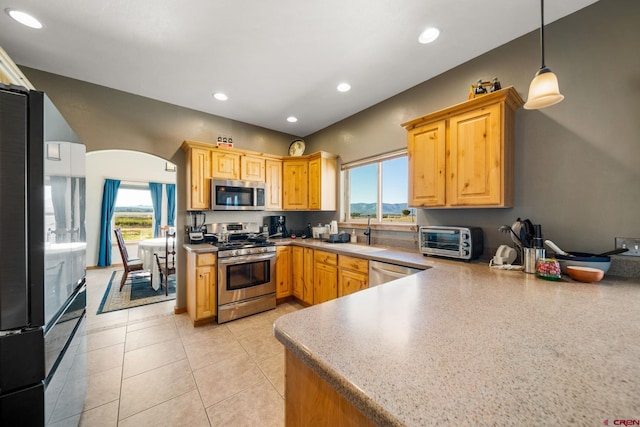 11611 Rd 28.1, Dolores, CO 81323 - kitchen with appliances with stainless steel finishes, arched walkways, pendant lighting, recessed lighting, and light tile patterned floors