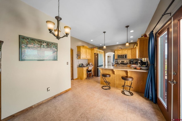11611 Rd 28.1, Dolores, CO 81323 - kitchen featuring appliances with stainless steel finishes, arched walkways, a chandelier, a peninsula, and light countertops