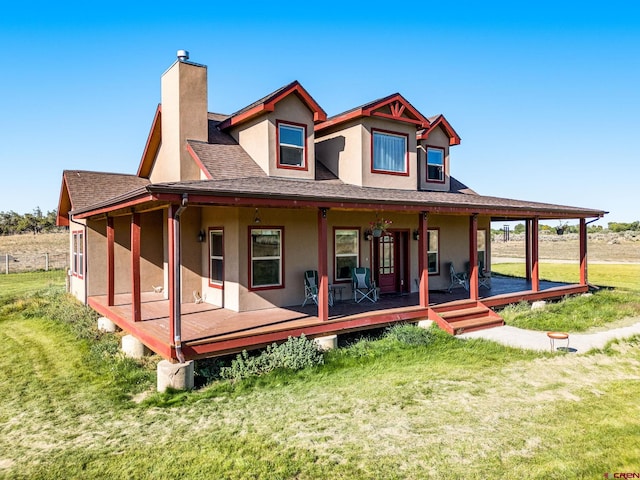 11611 Rd 28.1, Dolores, CO 81323 - back of house featuring a chimney, stucco siding, a lawn, roof with shingles, and a porch