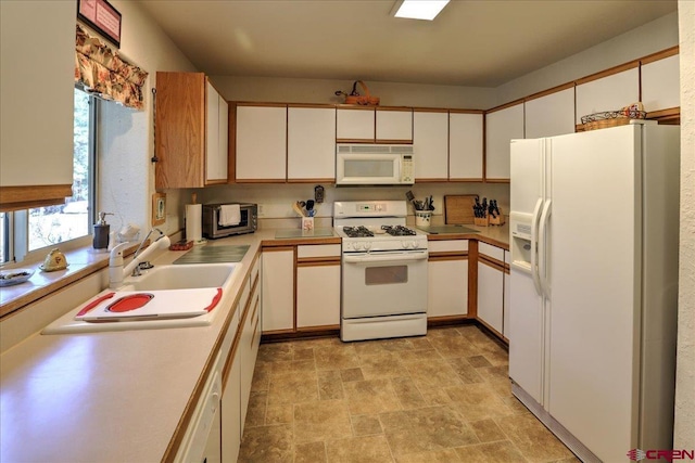 16 Mosswood Dr, Pagosa Springs, CO 81147 - kitchen with white appliances, stone finish floors, light countertops, a sink, and white cabinetry