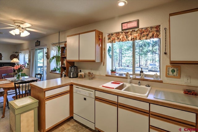 16 Mosswood Dr, Pagosa Springs, CO 81147 - kitchen featuring white dishwasher, a sink, light countertops, a peninsula, and plenty of natural light