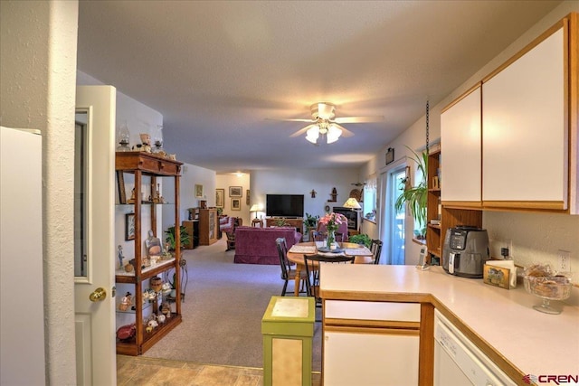 16 Mosswood Dr, Pagosa Springs, CO 81147 - kitchen featuring light countertops, ceiling fan, white cabinets, white dishwasher, and open floor plan