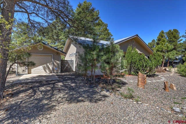 16 Mosswood Dr, Pagosa Springs, CO 81147 - view of front of house with an outbuilding, a detached garage, driveway, and fence