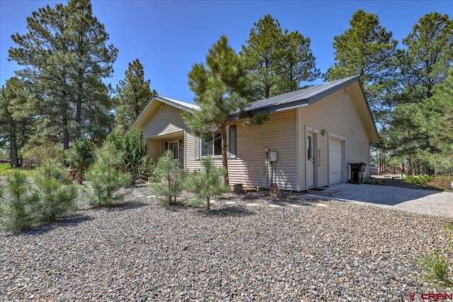 16 Mosswood Dr, Pagosa Springs, CO 81147 - view of front of home with an attached garage and gravel driveway