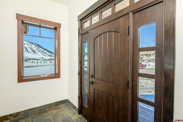 70 Lexie Ct, Crested Butte, CO 81224 - entryway featuring baseboards, a mountain view, and dark stone finish floors
