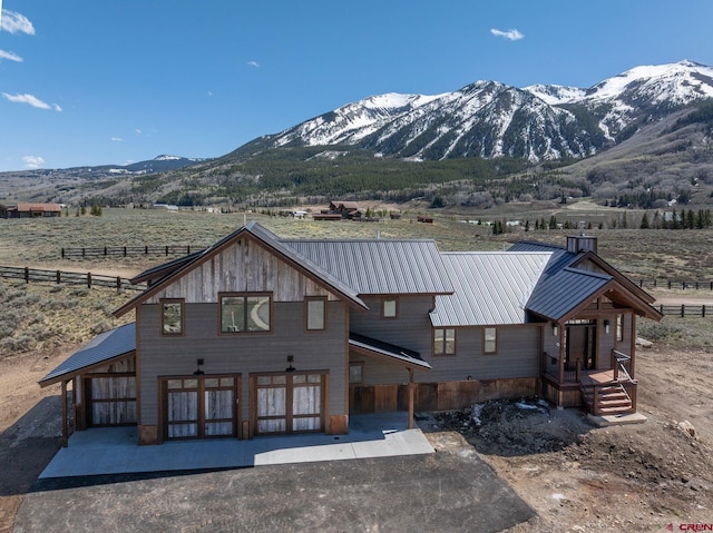 70 Lexie Ct, Crested Butte, CO 81224 - rear view of property featuring a mountain view, metal roof, and a view of countryside