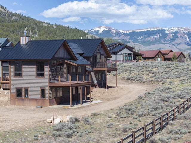 70 Lexie Ct, Crested Butte, CO 81224 - rear view of property featuring a standing seam roof, a deck with mountain view, and metal roof