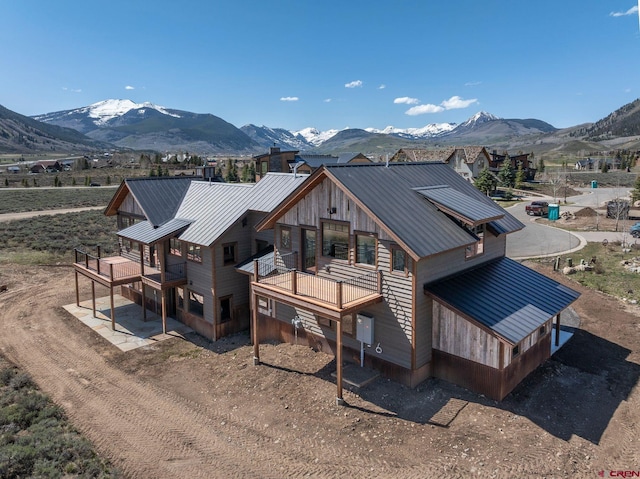 70 Lexie Ct, Crested Butte, CO 81224 - back of house with metal roof, a standing seam roof, and a deck with mountain view