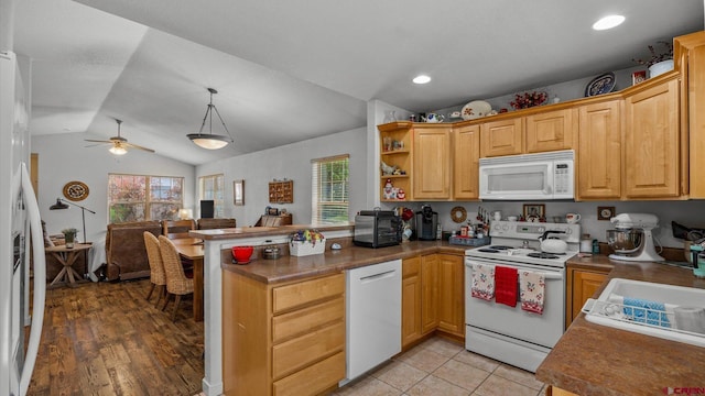 2384 Ridge Circle Dr Unit 14, Grand Junction, CO 81507 - kitchen featuring white appliances, healthy amount of natural light, a peninsula, ceiling fan, and vaulted ceiling