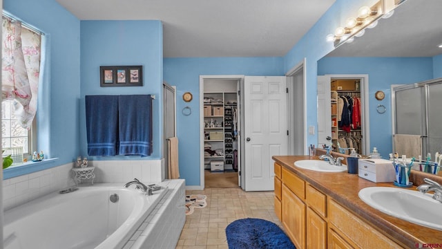2384 Ridge Circle Dr Unit 14, Grand Junction, CO 81507 - bathroom featuring a shower stall, a bath, double vanity, and a walk in closet