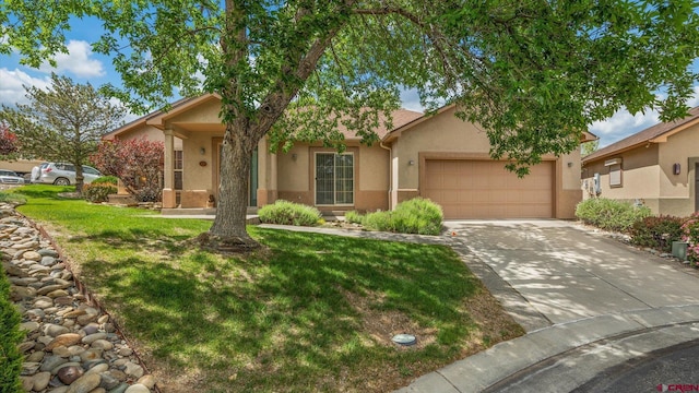 2384 Ridge Circle Dr Unit 14, Grand Junction, CO 81507 - view of front facade featuring stucco siding, a garage, concrete driveway, and a front yard