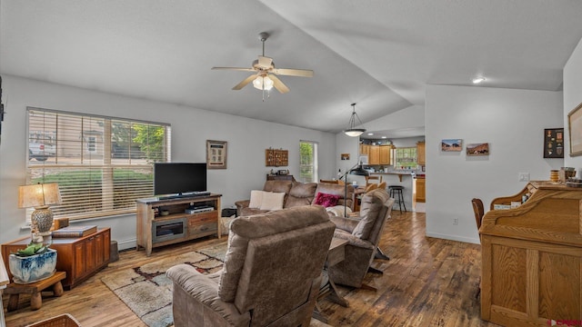2384 Ridge Circle Dr Unit 14, Grand Junction, CO 81507 - living room featuring a ceiling fan, vaulted ceiling, wood finished floors, baseboards, and baseboard heating