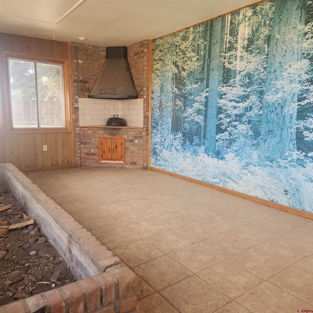 1016 Ln 12 N, Hooper, CO 81136 - unfurnished living room featuring wood walls and a wood stove
