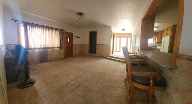 1016 Ln 12 N, Hooper, CO 81136 - tiled living room with wainscoting and arched walkways