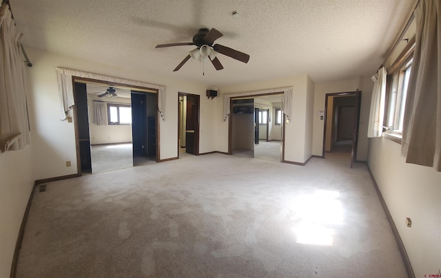 1016 Ln 12 N, Hooper, CO 81136 - spare room with a ceiling fan, baseboards, a textured ceiling, and light carpet