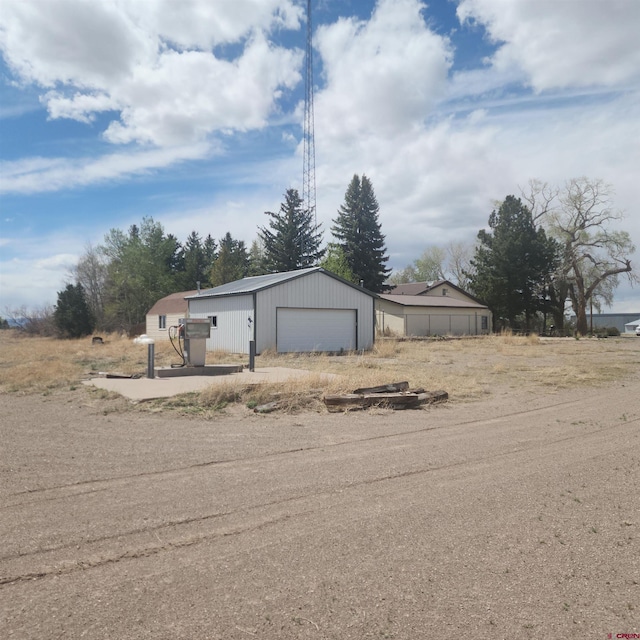 1016 Ln 12 N, Hooper, CO 81136 - view of yard featuring an outbuilding and a garage