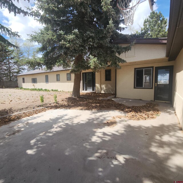 1016 Ln 12 N, Hooper, CO 81136 - view of front of property with stucco siding and a patio